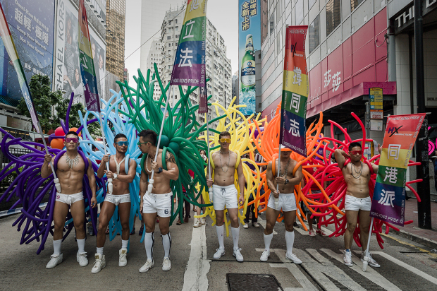 Participants hold flags during the gay pride parade in Hong Kong on November 9, 2013. Despite its reputation as an international financial hub, critics say Hong Kong remains a conservative city when it comes to gay rights, lacking protection for the sexual minority group despite having decriminalised homosexuality in 1991. AFP PHOTO / Philippe Lopez (Photo credit should read PHILIPPE LOPEZ/AFP/Getty Images)