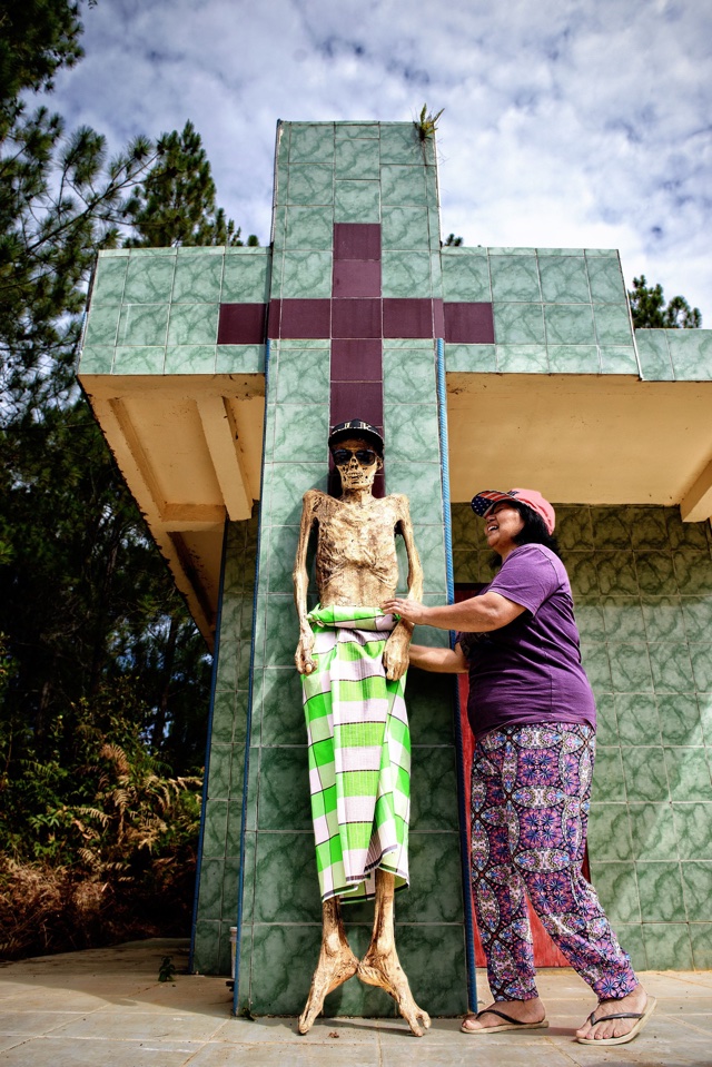 Mandatory Credit: Photo by Herman Morrison/Solent News/REX/Shutterstock (5661812c) The corpses having been dressed and paraded round the village Ceremony of Cleaning Corpses during Ma'nene festival, South Sulawesi, Indonesia - Apr 2016 *Full story: http://www.rexfeatures.com/nanolink/s97d Centuries-old corpses are exhumed, dressed in clothes and put on display in a macabre ritual honouring the dead. The preserved bodies of ancestors of the Toraja, an ethnic group from the mountains of South Sulawesi in Indonesia, are lovingly dug up from their graves as part of the ancient Ma'nene festival. The annual festival, which translates to 'the Ceremony of Cleaning Corpses', then sees the dead groomed, washed, dressed in fashionable new clothes and even sunglasses and paraded round the village. The scenes might appear gruesome but for the Toraja people, who consider funerals the most important event of their lives, the festival is a celebration. Photographer Herman Morrison made the trip from Indonesian island Lombok, where he lives, to capture the peculiar ceremony on camera.